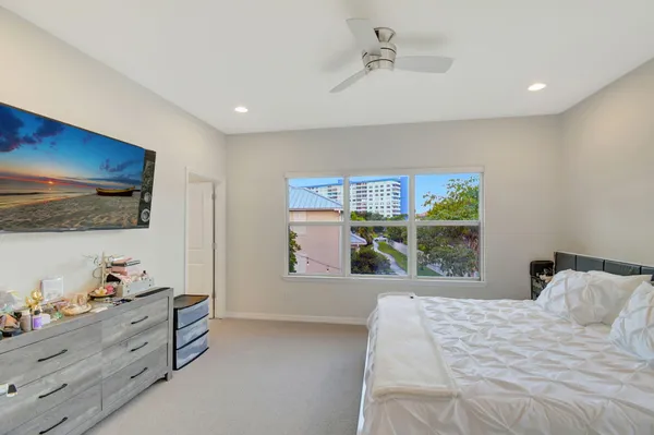 a bedroom with furniture and large window