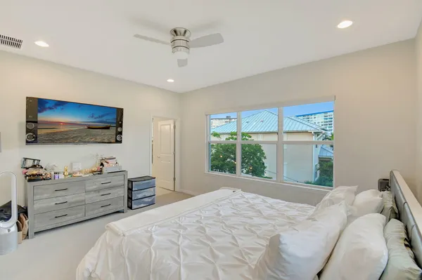 a bedroom with a large bed and a flat screen tv