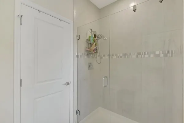 a bathroom with a glass shower door