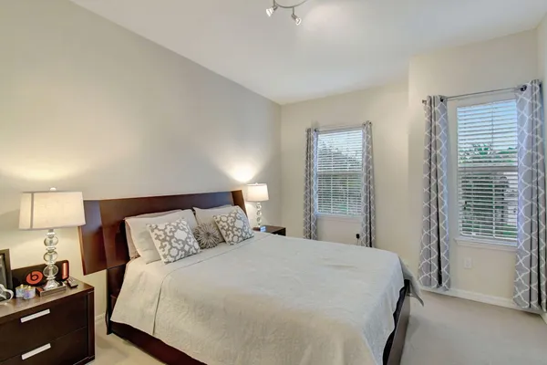 a bedroom with a bed and a window