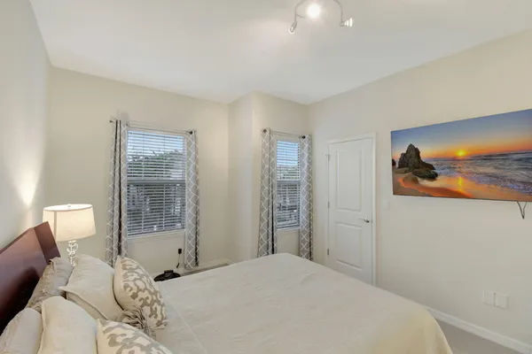 a bedroom with a bed and a painting on the wall
