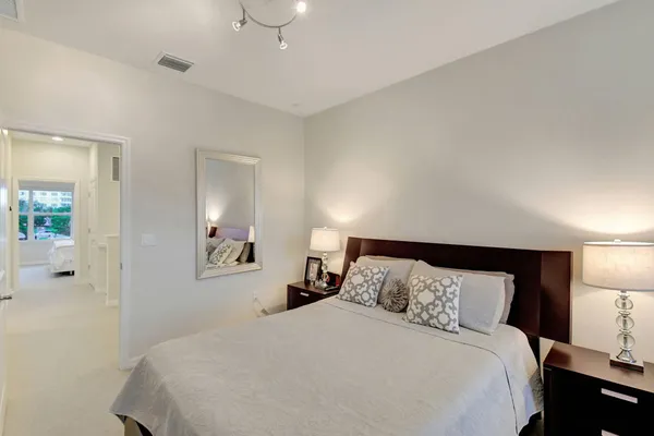 a bedroom with a bed and mirror