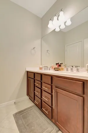 a bathroom with a sink vanity and a mirror