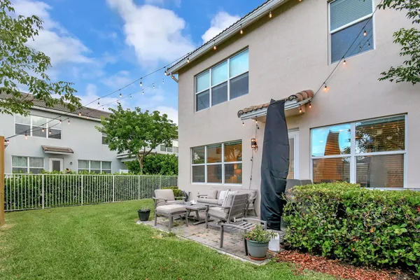 a view of a house with backyard sitting area and garden