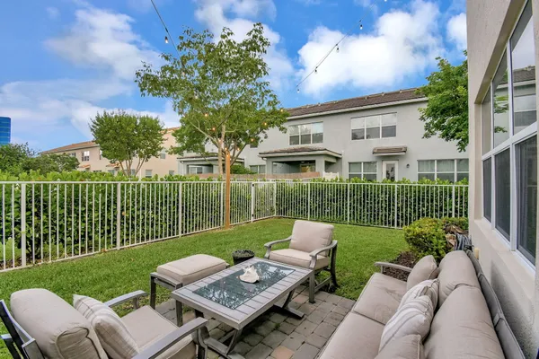 a view of a house with backyard and sitting area