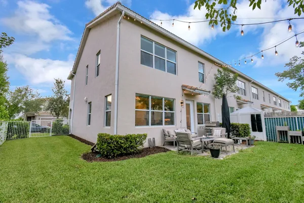 a view of a house with backyard sitting area and garden