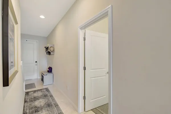 a view of a hallway with bathroom