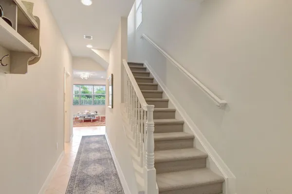 a view of entryway and hall with wooden floor