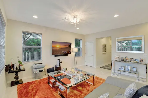 a living room with furniture a large window and a flat screen tv