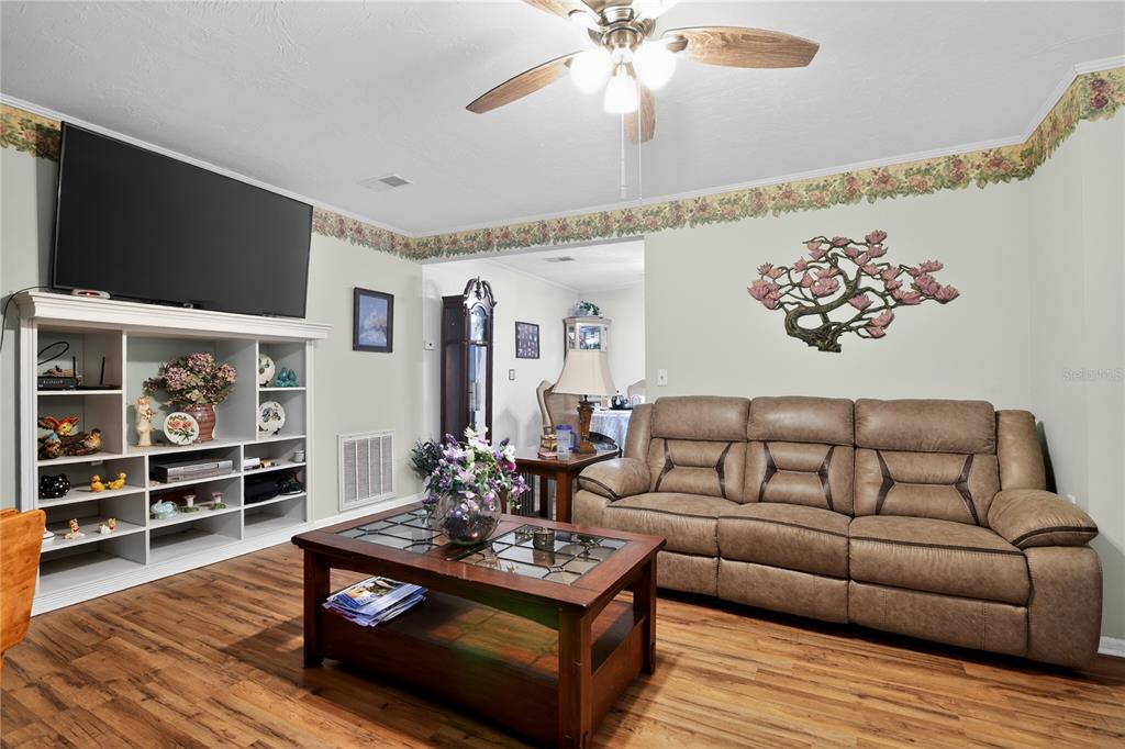 1803 Southeast 3rd Avenue Ocala, FL 34471 - Photo 12 of 29 a living room with furniture a flat screen tv and kitchen view