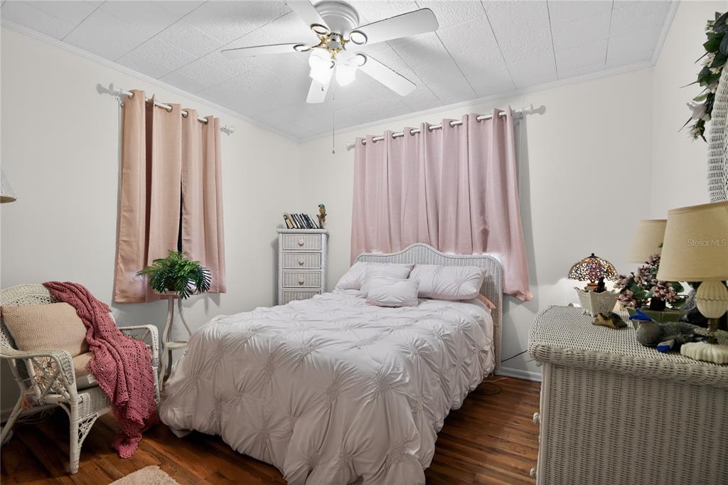 1803 Southeast 3rd Avenue Ocala, FL 34471 - Photo 17 of 29 a bedroom with bed and a chandelier