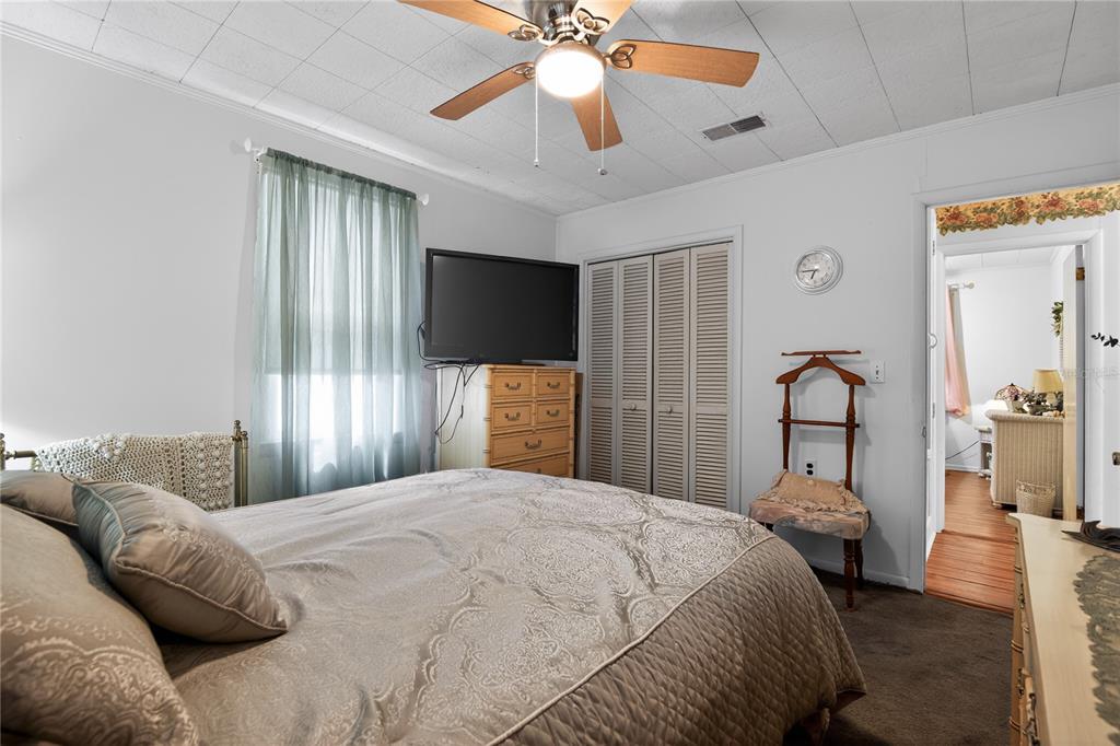 1803 Southeast 3rd Avenue Ocala, FL 34471 - Photo 19 of 29 a bedroom with a large bed and a chandelier