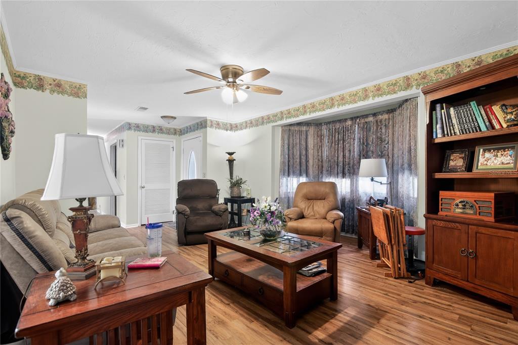 1803 Southeast 3rd Avenue Ocala, FL 34471 - Photo 4 of 29 a living room with furniture a bookshelf and a window
