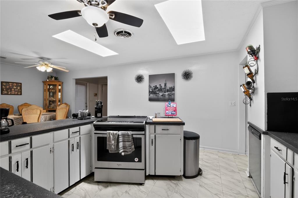 1803 Southeast 3rd Avenue Ocala, FL 34471 - Photo 5 of 29 a kitchen with a stove and a microwave