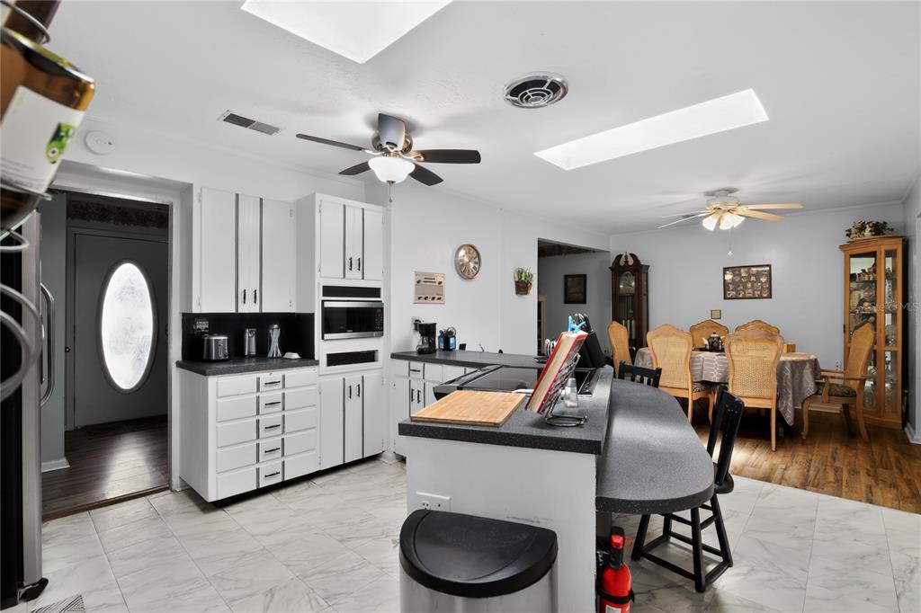 1803 Southeast 3rd Avenue Ocala, FL 34471 - Photo 6 of 29 a living room with furniture a flat screen tv and kitchen view