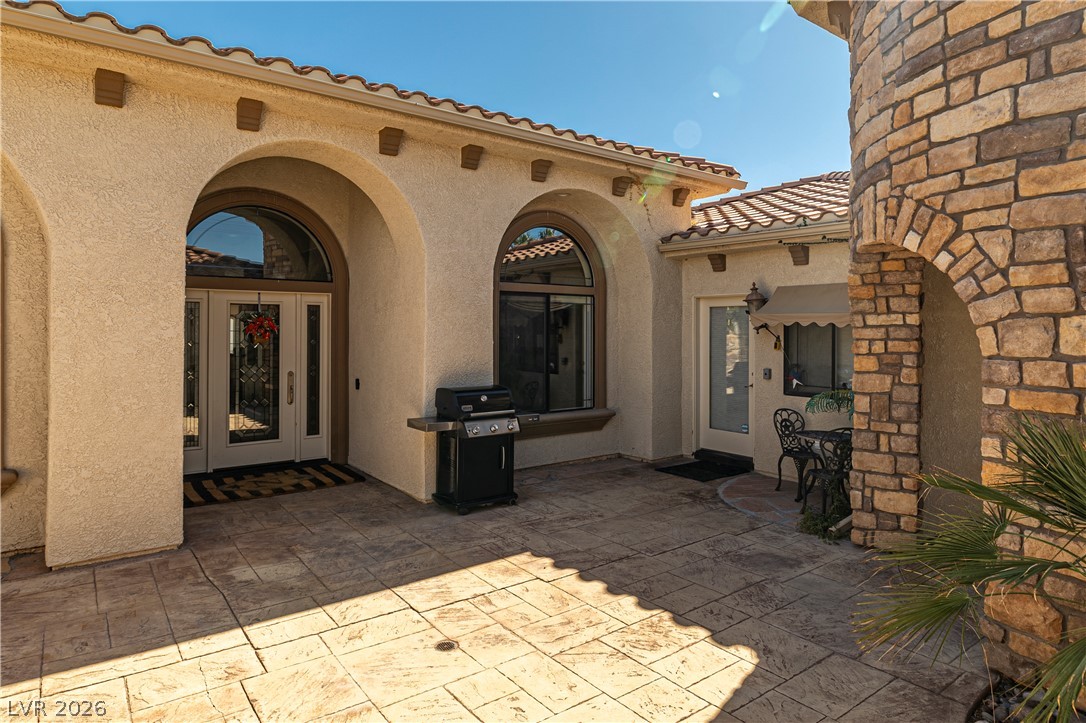 2181 Winery Road Pahrump, NV 89048 - Photo 7 of 52 Arched entryways and a stamped concrete patio create a peaceful outdoor living space.
