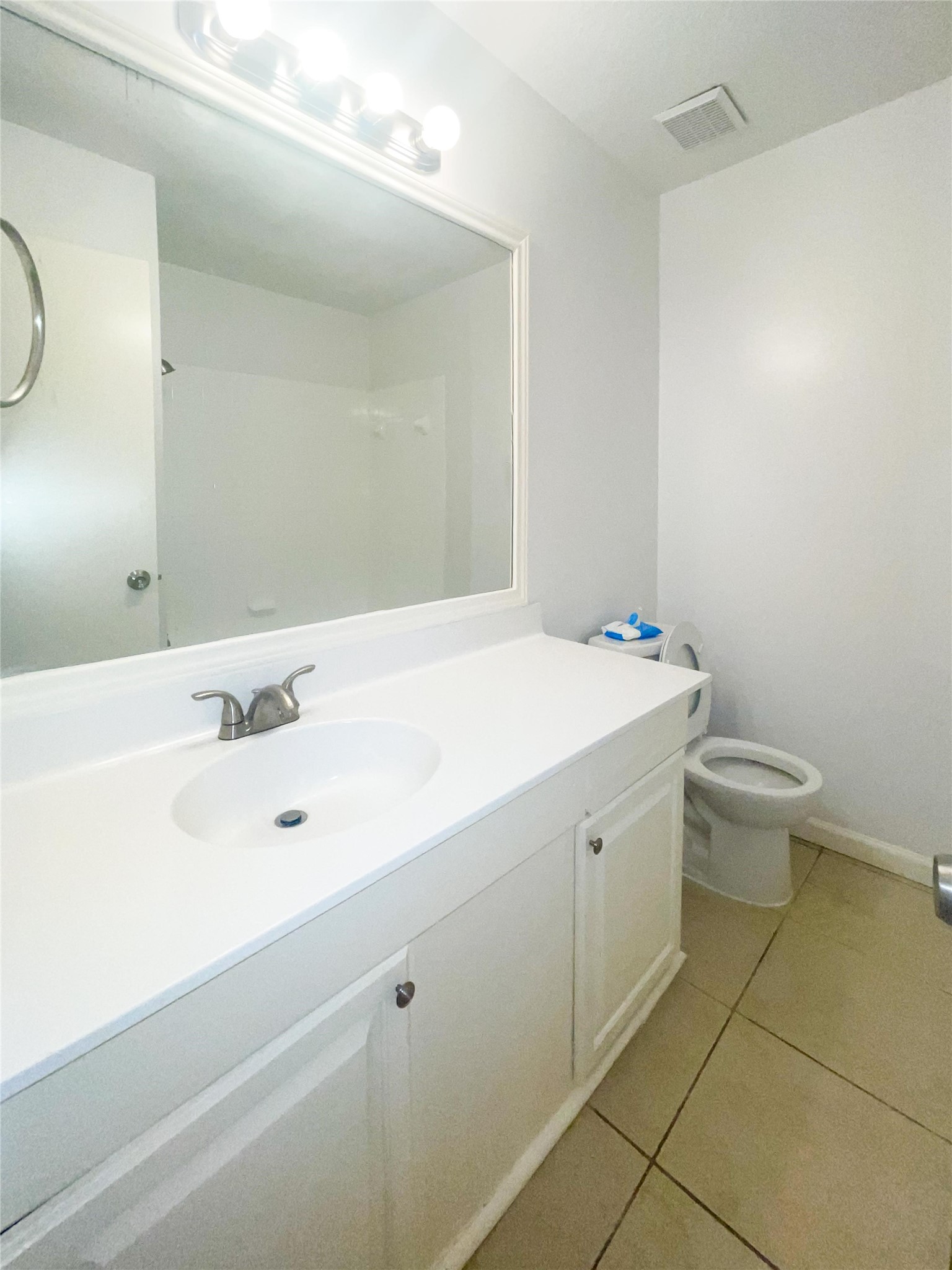 9506 Riverside Lodge Drive Houston, TX 77083 - Photo 11 of 16 a bathroom with a sink a toilet and a mirror