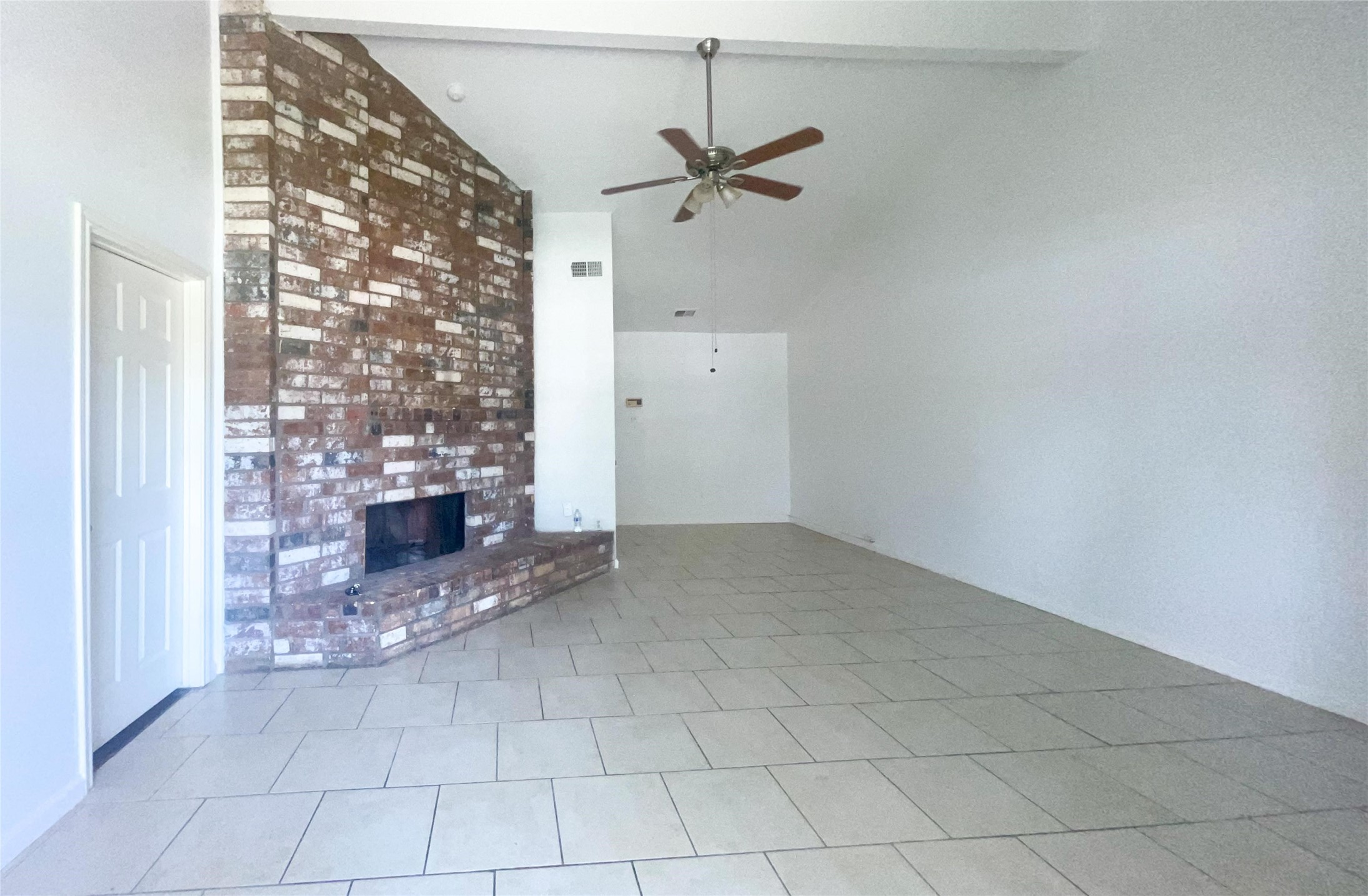 9506 Riverside Lodge Drive Houston, TX 77083 - Photo 2 of 16 an empty room with chandelier fan and windows