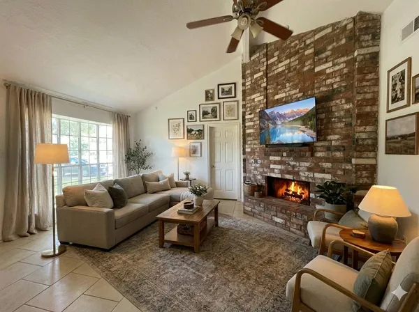 a living room with furniture and a fireplace
