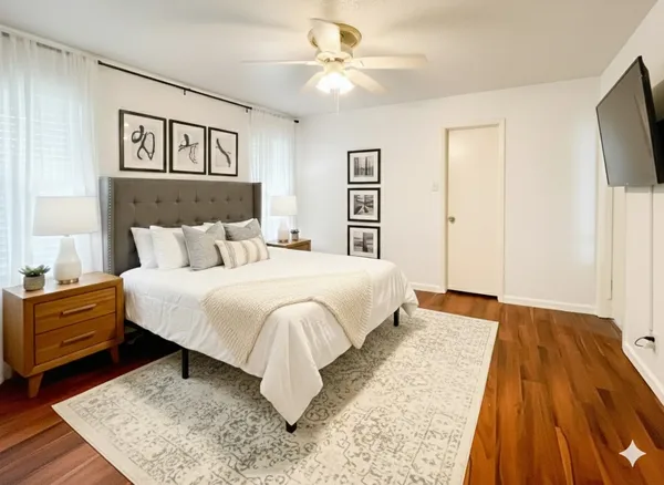 a bedroom with a bed and a chandelier
