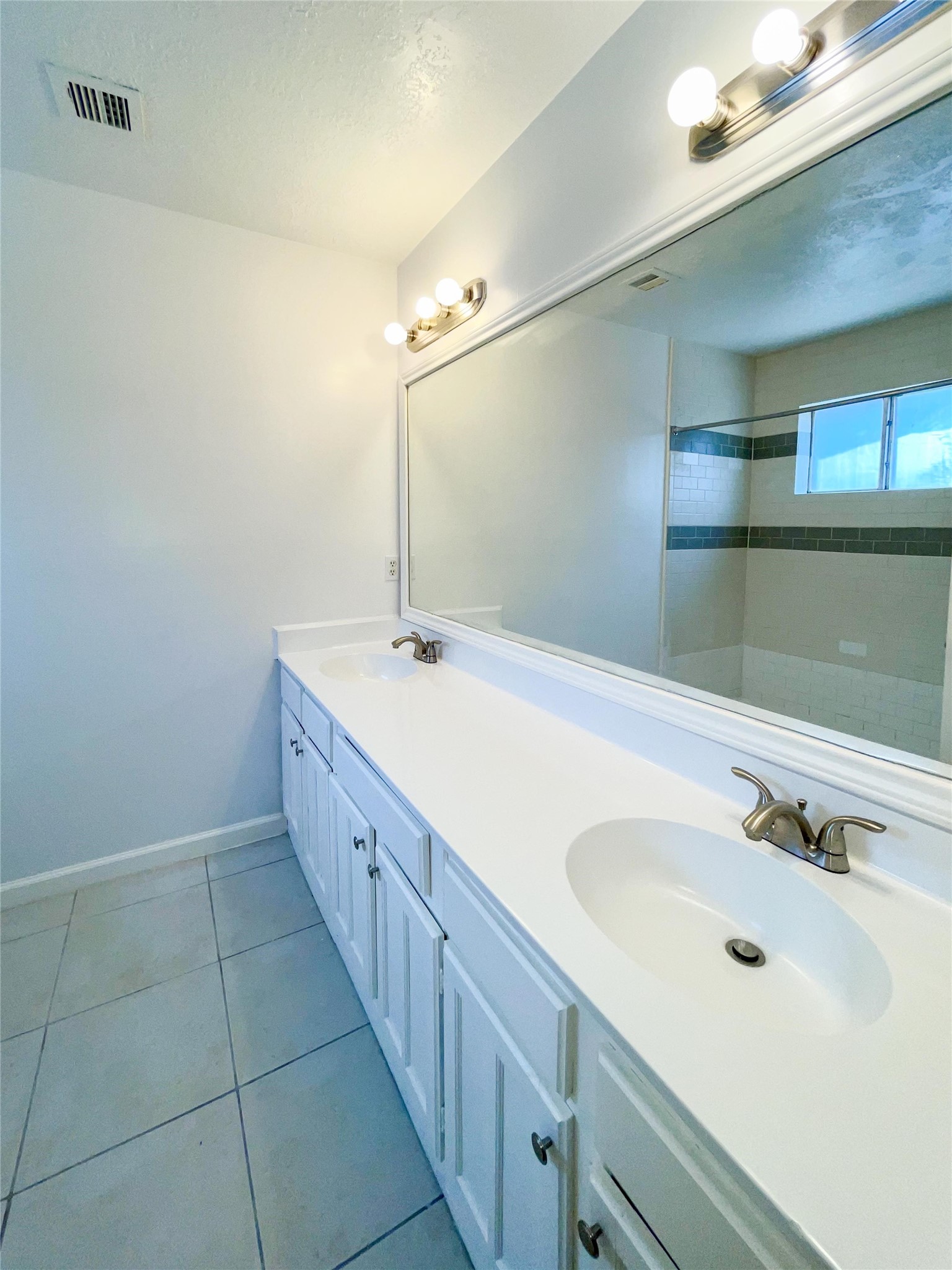 9506 Riverside Lodge Drive Houston, TX 77083 - Photo 10 of 16 a spacious bathroom with a double vanity sink and mirror