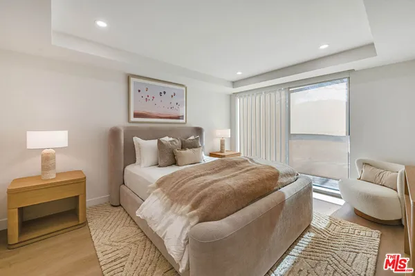 a spacious bedroom with a bed and a couch