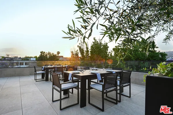 an outdoor space with furniture and garden view