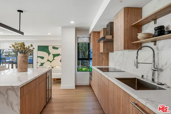 a kitchen with stainless steel appliances kitchen island a sink stove and cabinets