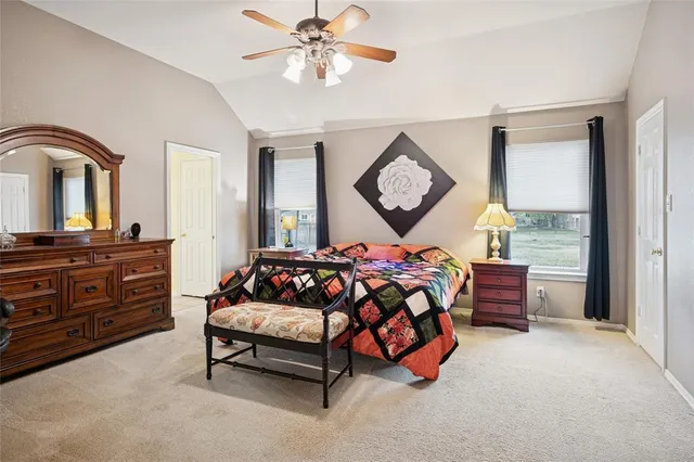 a bedroom with a bed window and dresser