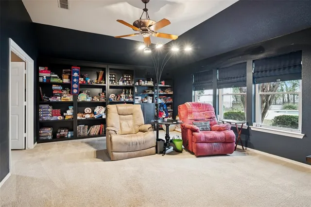a living room with lots of furniture and a large window