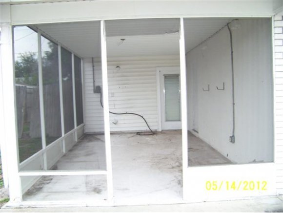 2959 Northeast Gemini Palm Bay, FL 32905 - Photo 10 of 12 a view of a hallway with a glass door