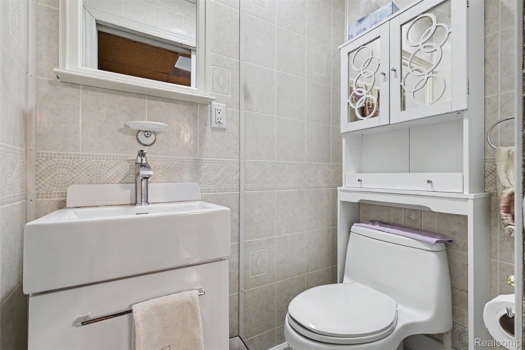45223 Wear Road Belleville, MI 48111 - Photo 36 of 60 White ceramic wall-mounted sink with a chrome faucet