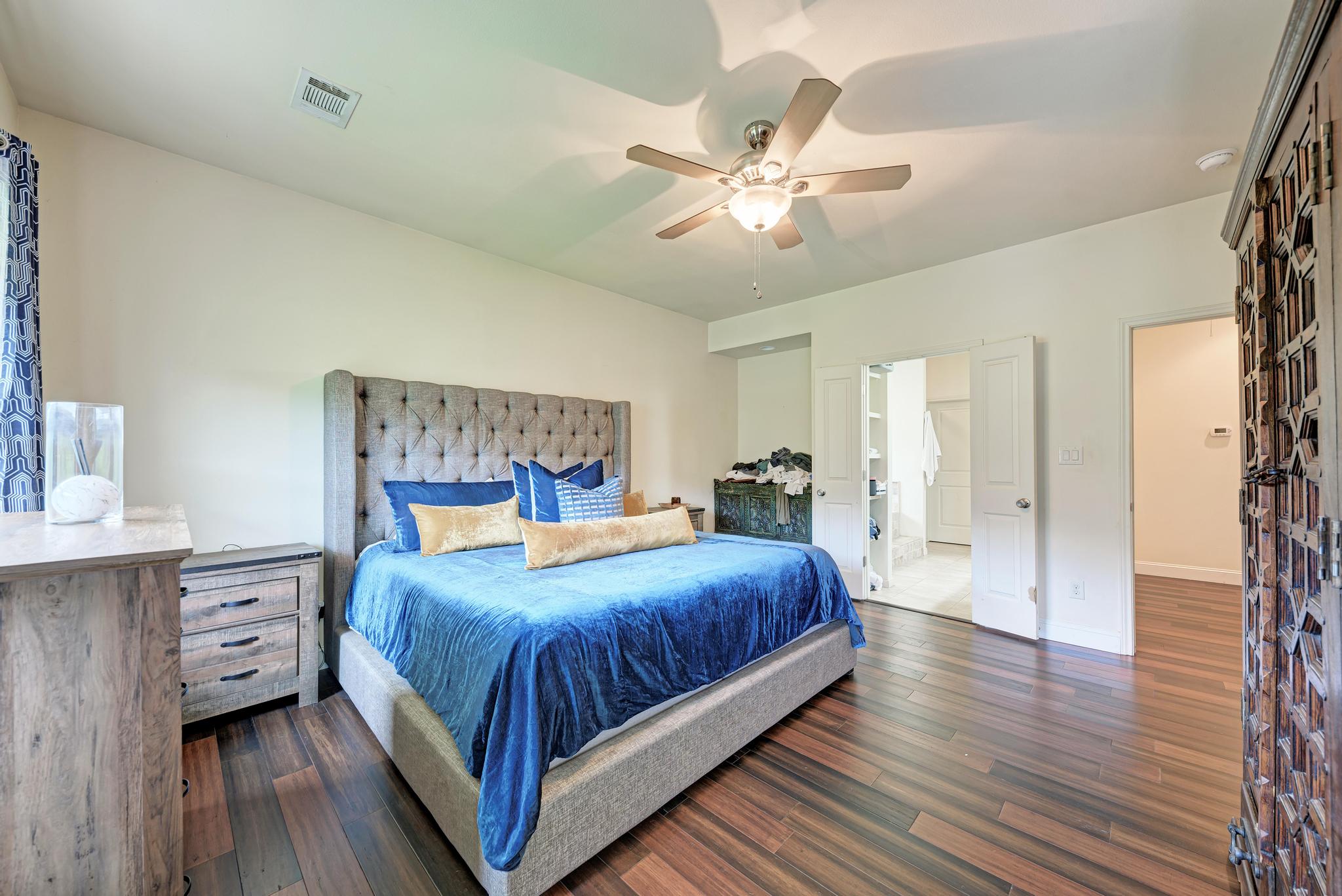 2605 Indian Creek Road Austin, TX 78734 - Photo 12 of 33 Spacious room featuring wood-finish flooring, a ceiling fan with integrated lighting, and white walls