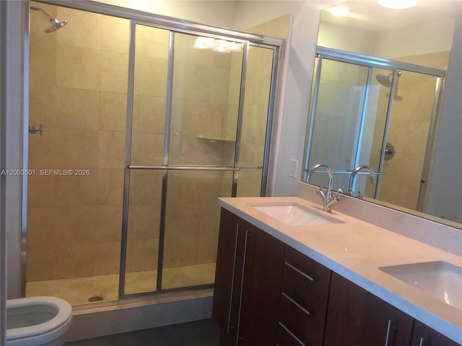 1111 Southwest 1st Avenue, Unit 2223N Miami, FL 33130 - Photo 12 of 39 a bathroom with a sink and a mirror