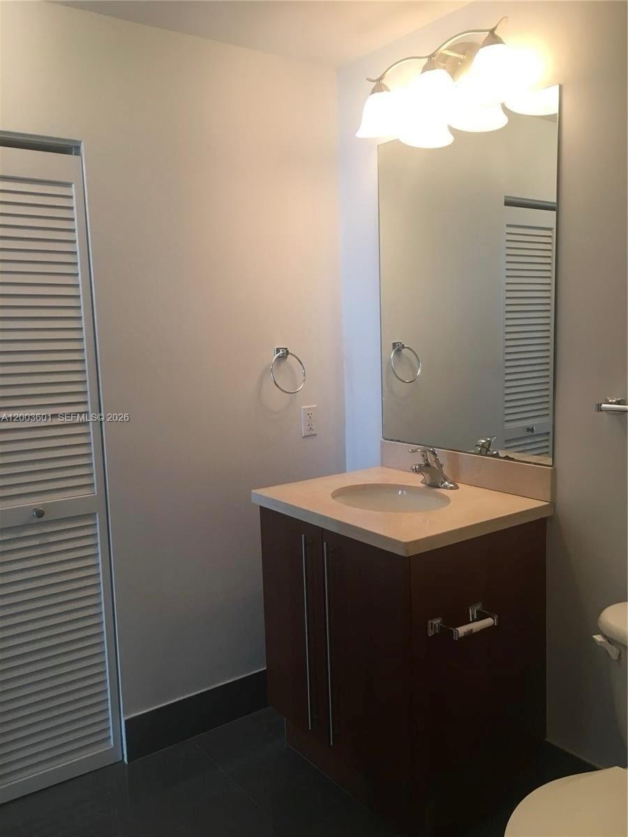 1111 Southwest 1st Avenue, Unit 2223N Miami, FL 33130 - Photo 15 of 39 a bathroom with a sink and mirror