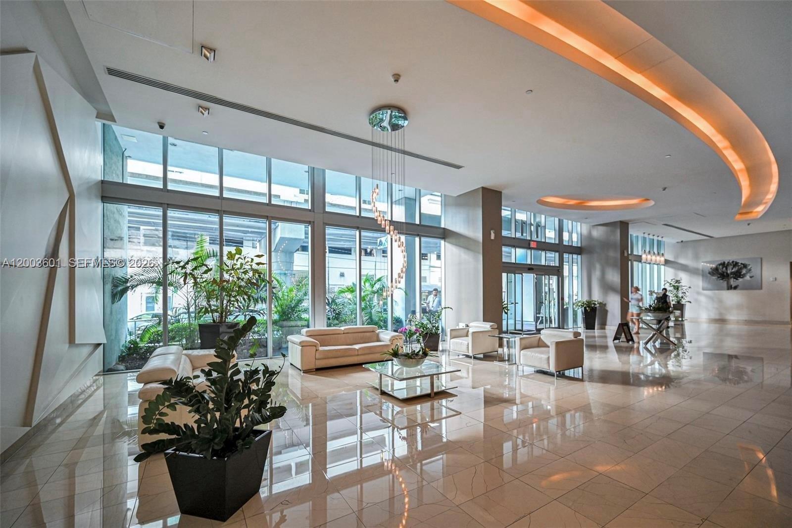 1111 Southwest 1st Avenue, Unit 2223N Miami, FL 33130 - Photo 3 of 39 a lobby with furniture and potted plants