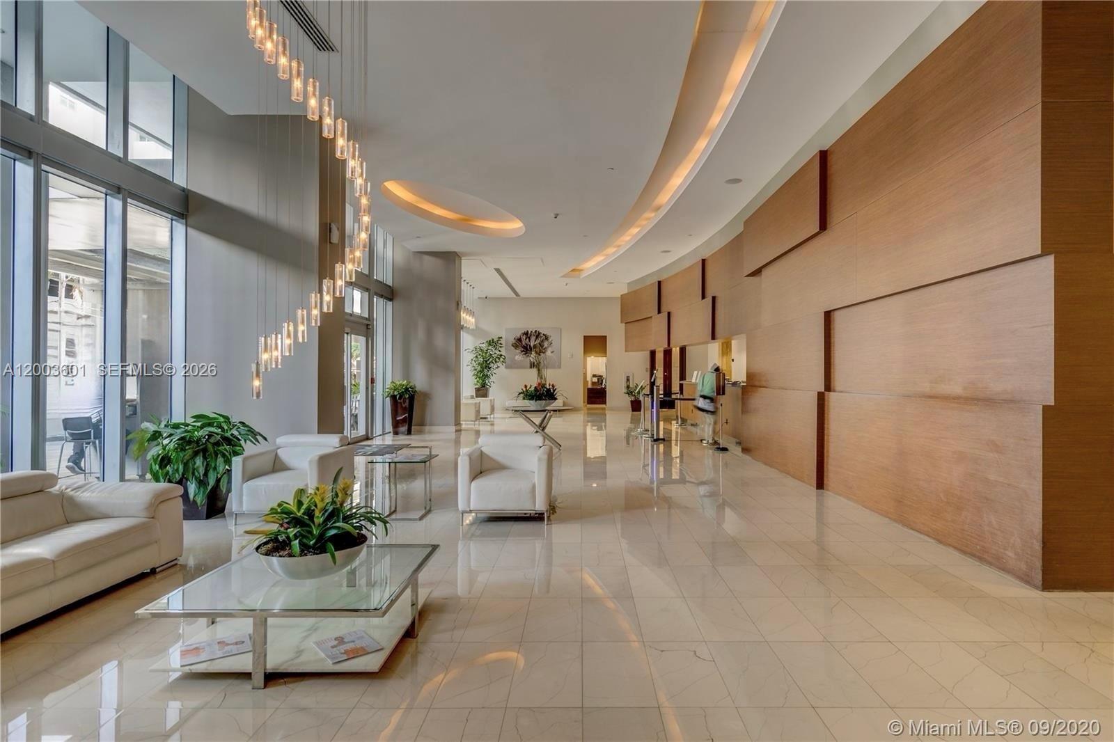 1111 Southwest 1st Avenue, Unit 2223N Miami, FL 33130 - Photo 5 of 39 a lobby with furniture and potted plant