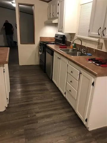 a kitchen with stainless steel appliances granite countertop a sink stove and cabinets