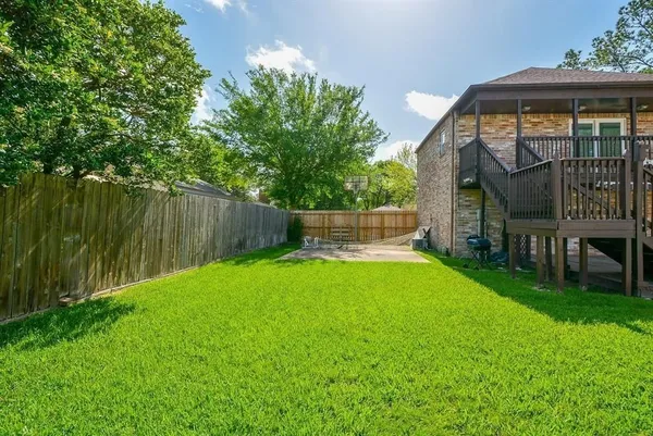 a view of backyard with a garden and deck