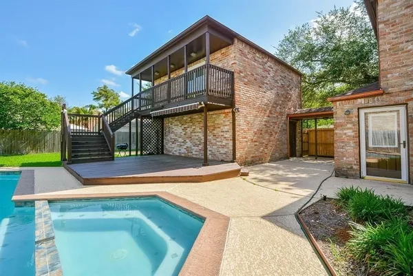 a view of a house with a swimming pool with a porch