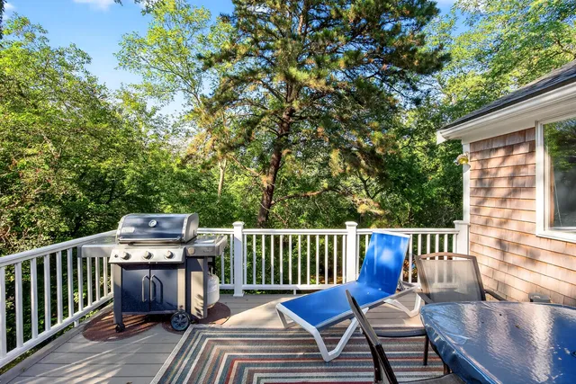 a view of a chair and table on the deck