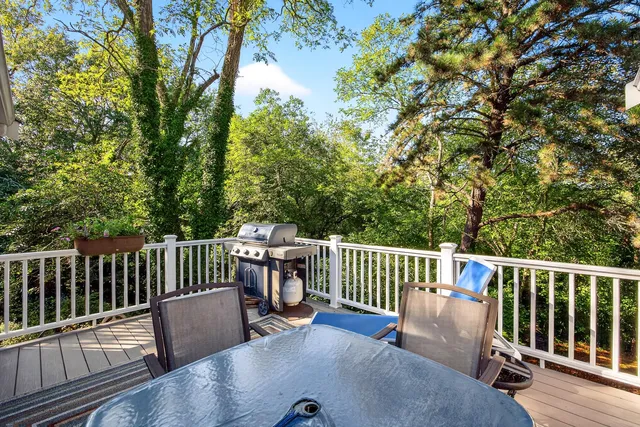 a view of a chair and table on the wooden deck