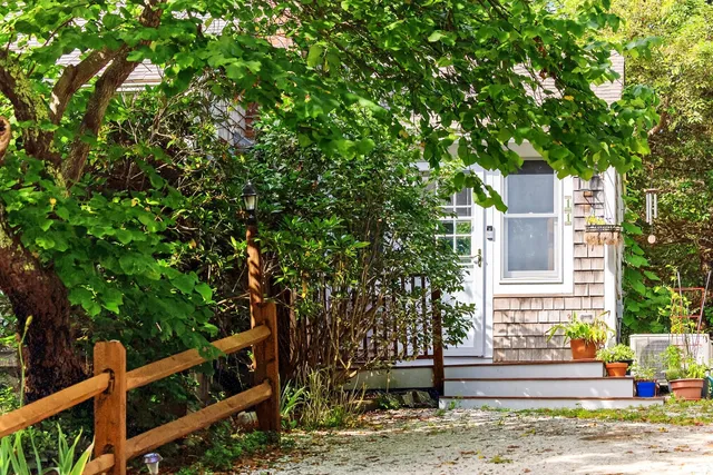 a front view of a house with trees