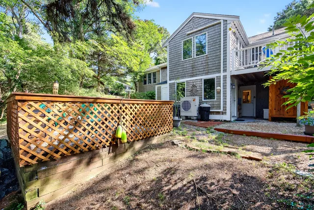 a view of house with backyard and sitting area