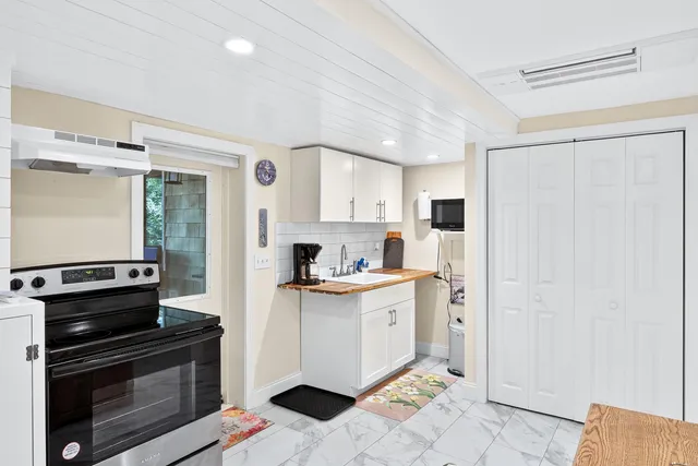 a kitchen with stainless steel appliances a stove a refrigerator and a cabinets