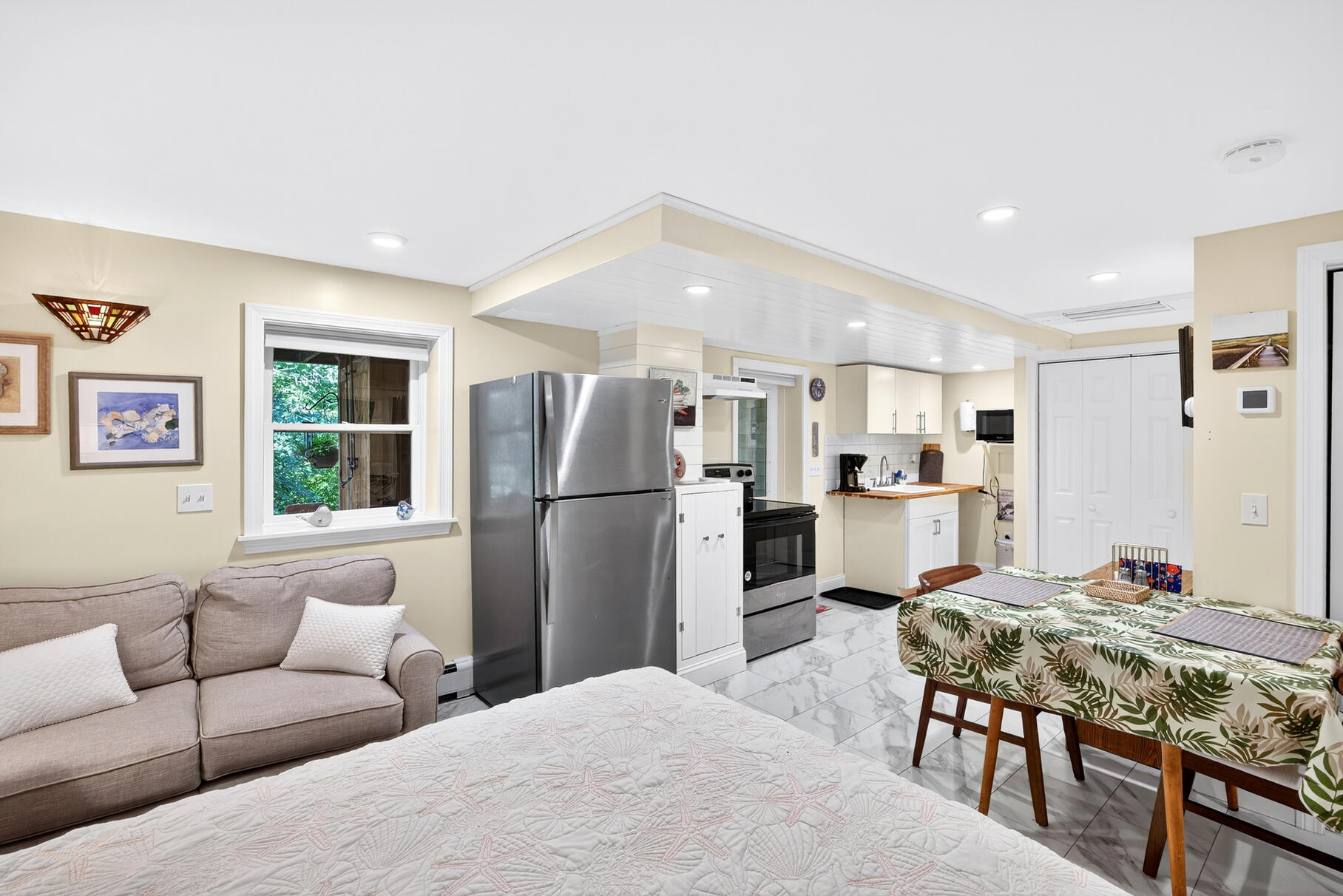 11 Whelpley Road Eastham, MA 02642 - Photo 32 of 37 a living room with kitchen island stainless steel appliances furniture a refrigerator a sink a counter top space and living room view