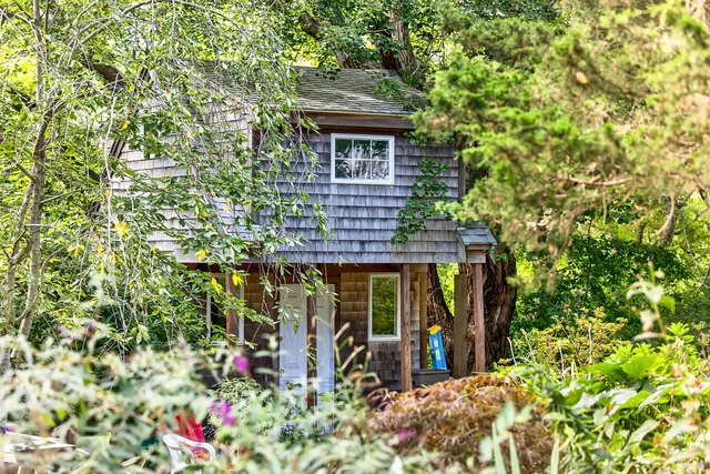 front view of a house with a tree