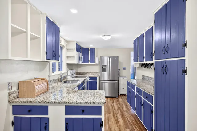 a kitchen with stainless steel appliances granite countertop wooden cabinets a sink and dishwasher