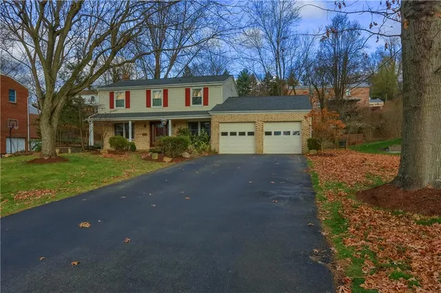 a view of house with yard in front of it