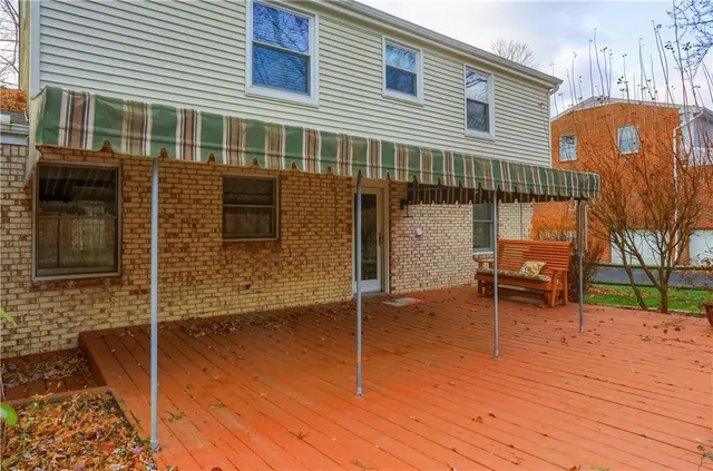 a backyard of a house with barbeque oven and outdoor seating